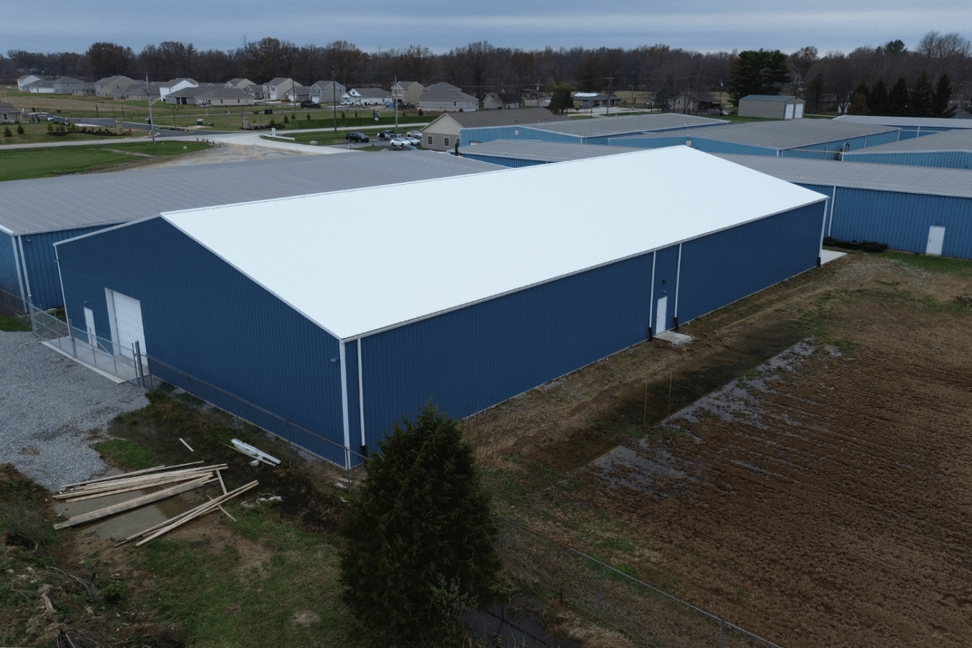 24x40 side view of blue garage pole barn kit with white roof and garage in felicity ohio