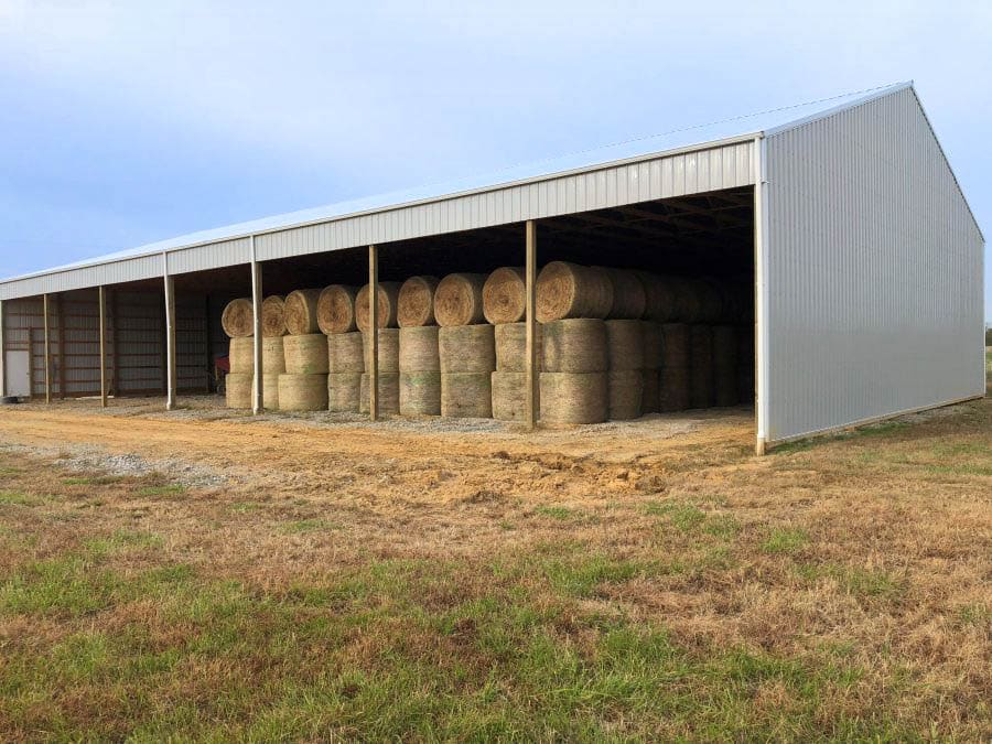 A 60x80 agricultural pole barn storing hay
