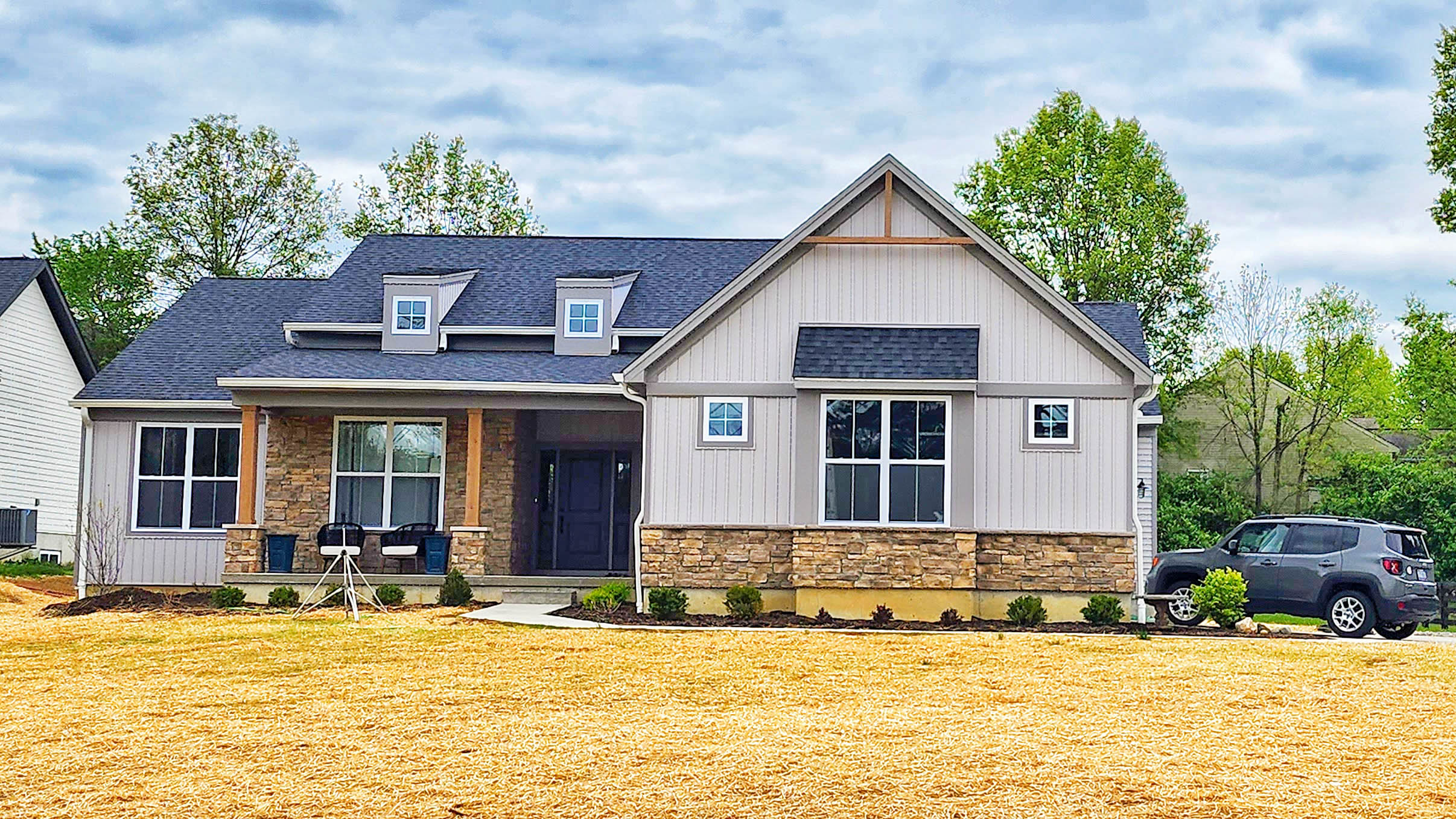 A 75x100 barndominium with stone and light grey siding