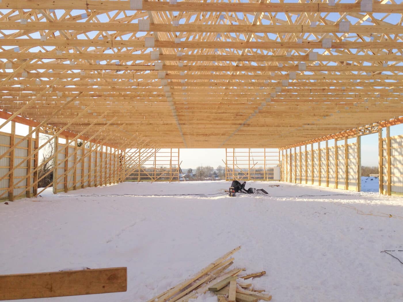 Exposed 80x120 roof trusses in the snow