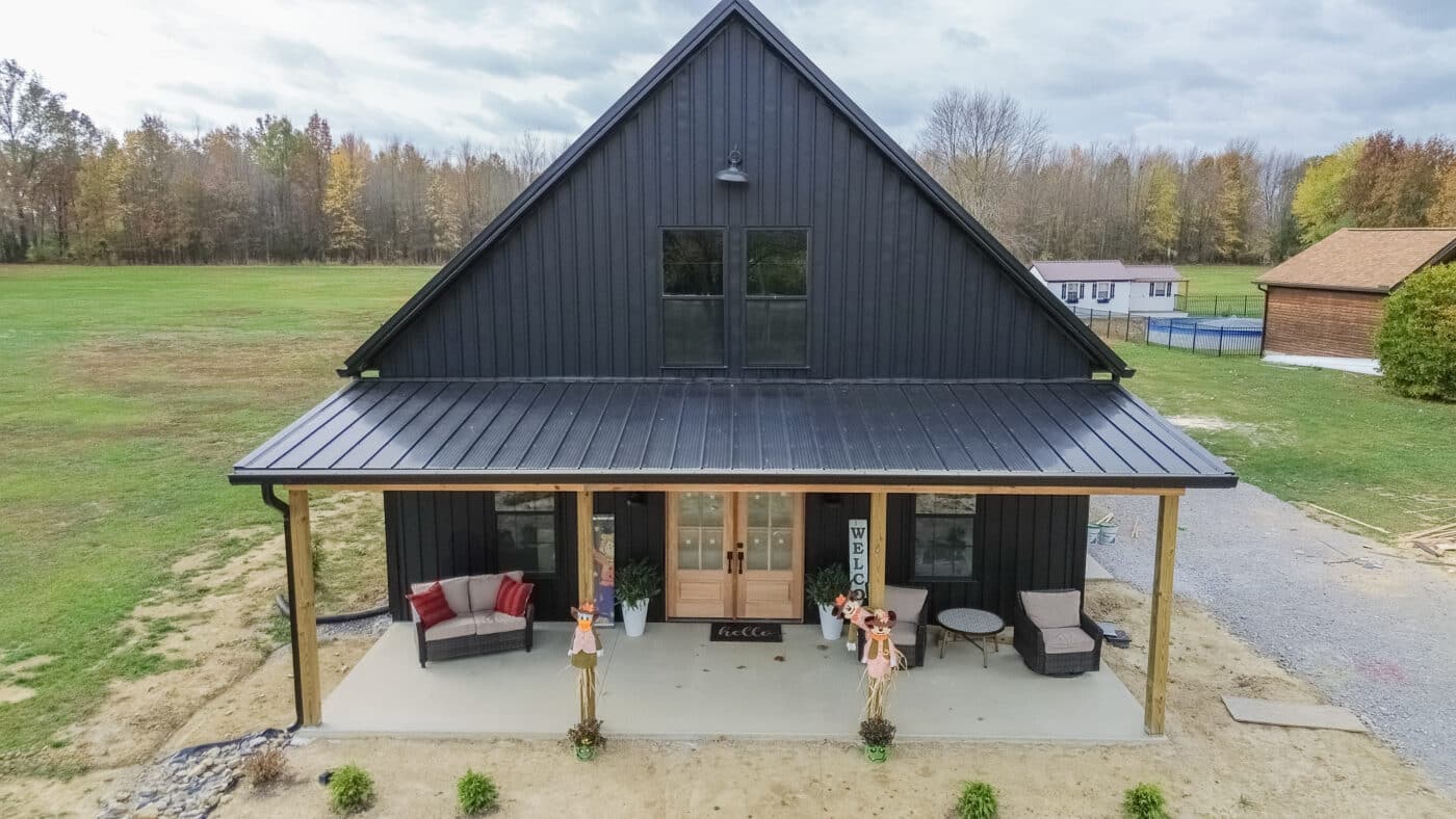 aerial front view of black 45x45 barndominium with front porch and overhang