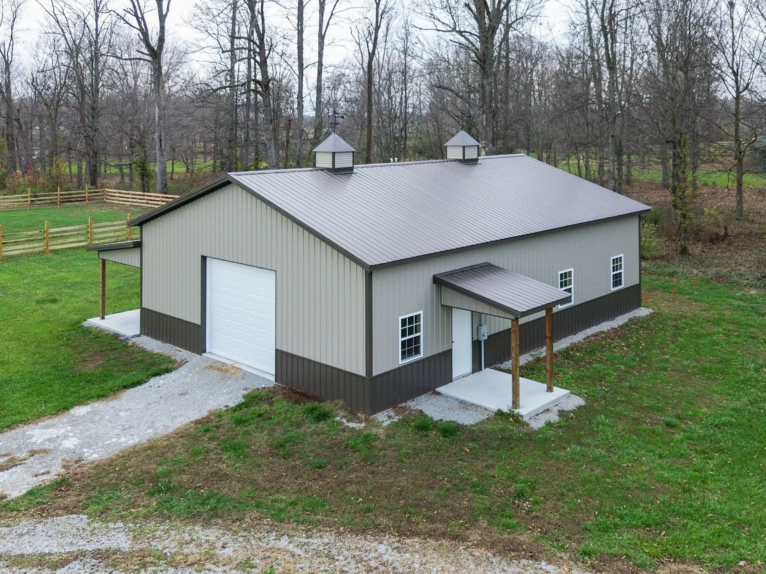 beige 30x48 garage pole barn with white garage and brown roof with cupolas