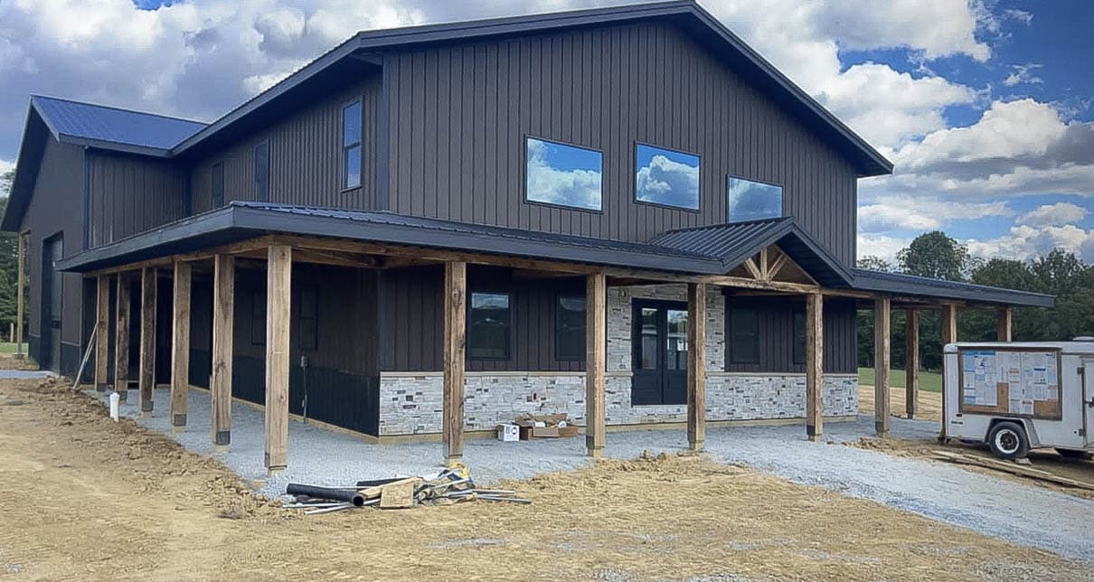 A black 36x60 barndominium with a porch