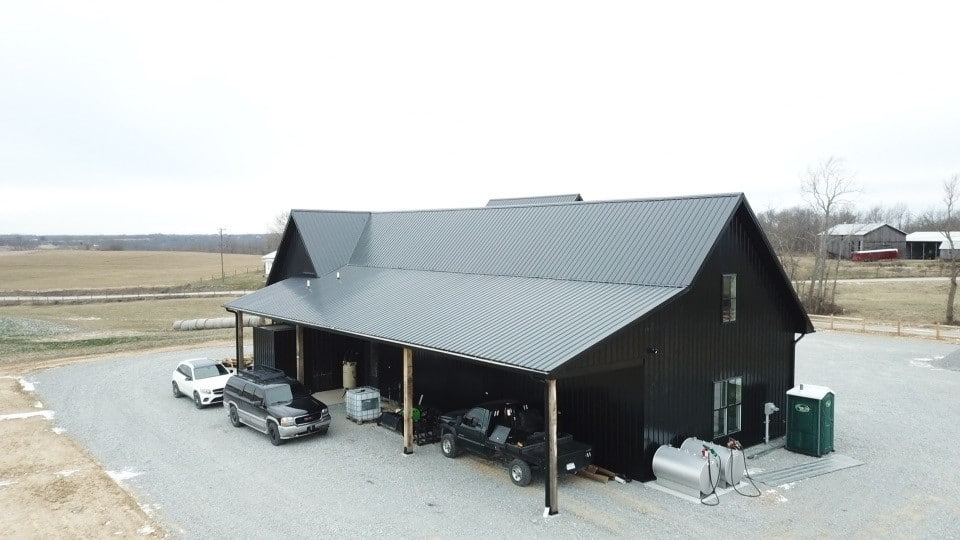 a black metal 24x24 barndominium on a cloudy day