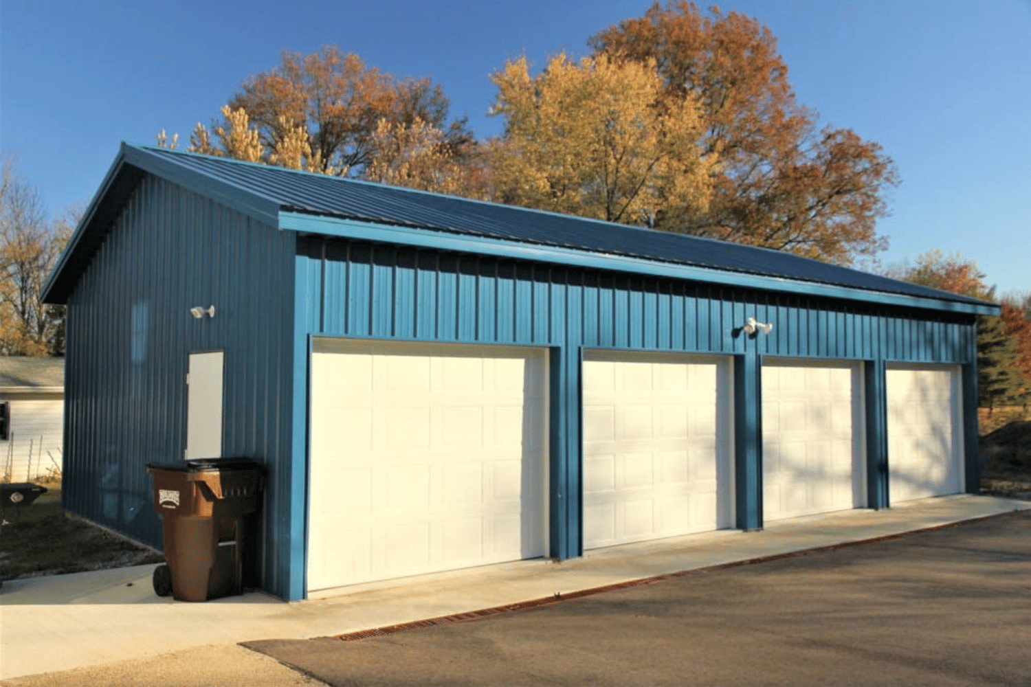 blue 50x60 garage pole barn kit with 4 white garages