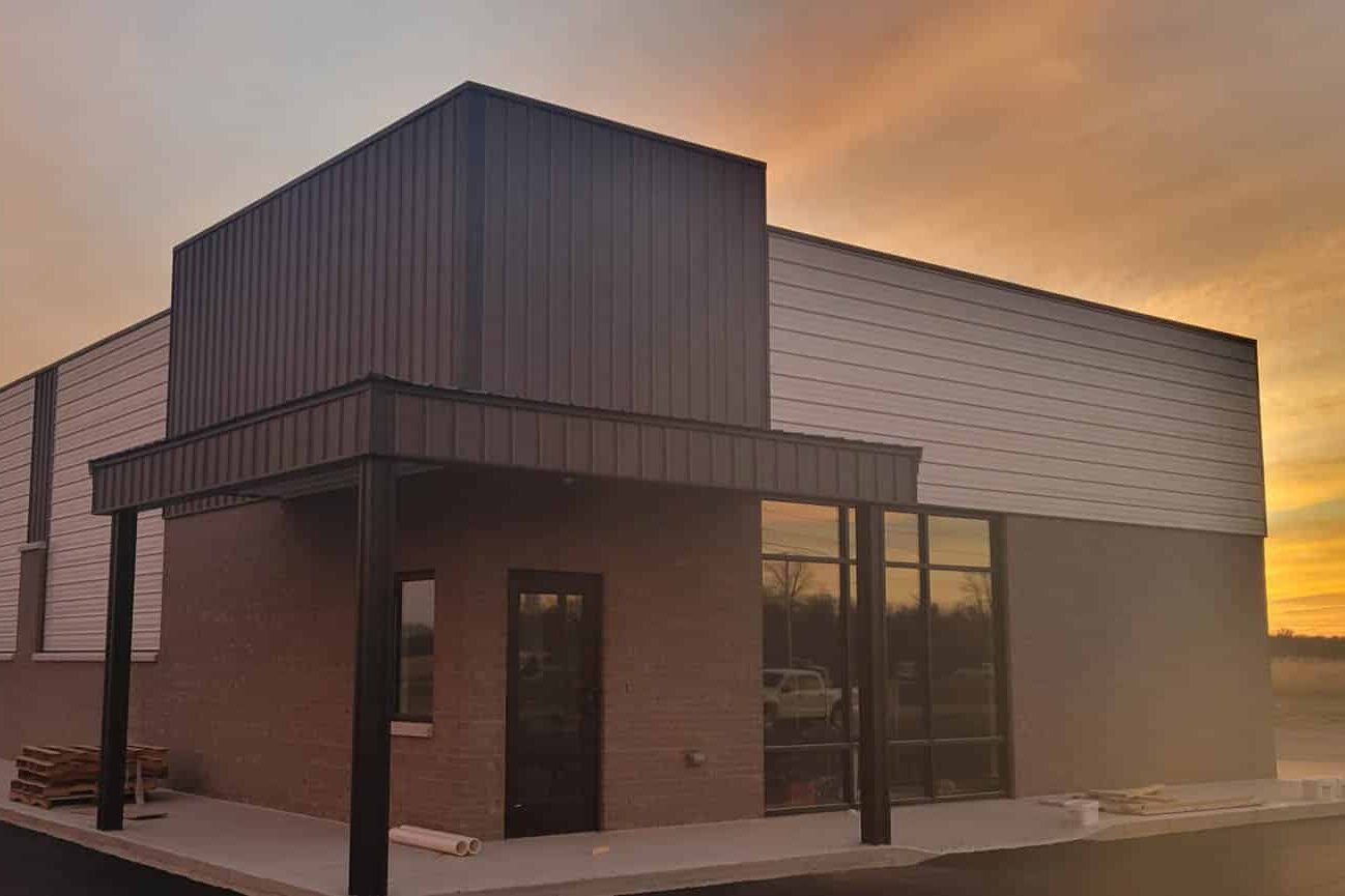 brick and tan and brown sided commercial pole barn