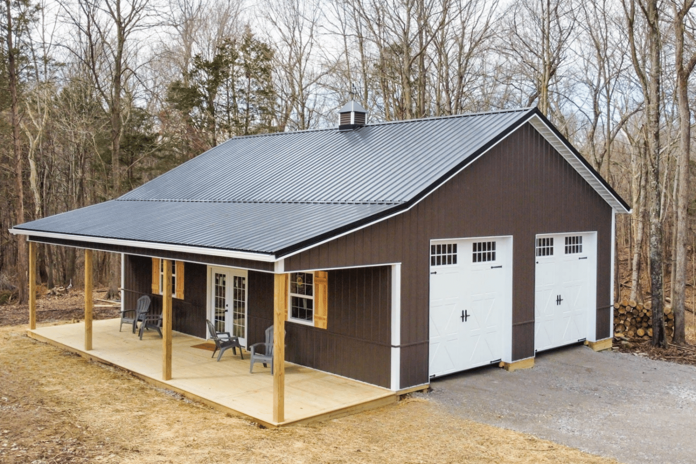 brown 50x50 barndominium with two white garages and porch
