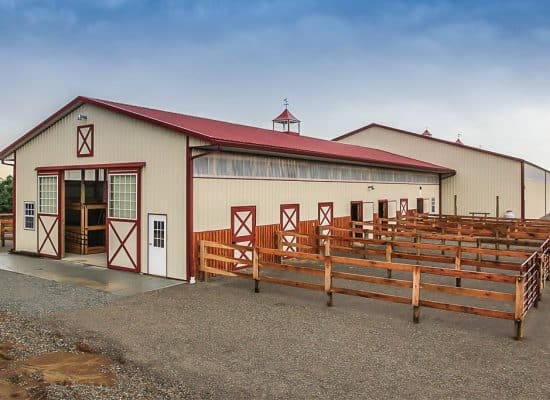 cream and red trimmed equestrian pole barn