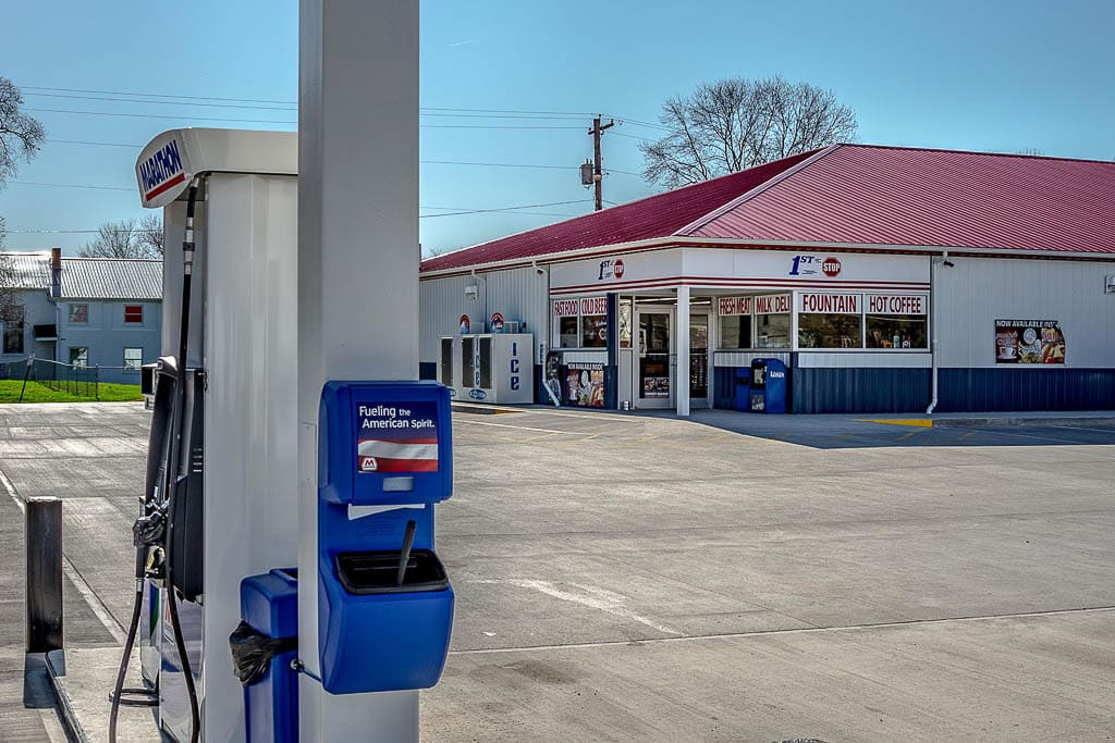 custom commercial pole barn gas station with blue white and red metal panels