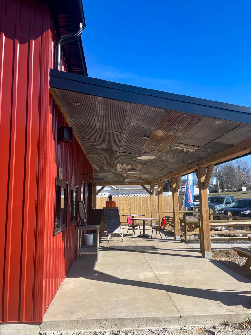 a red metal dairy barn exterior porch area