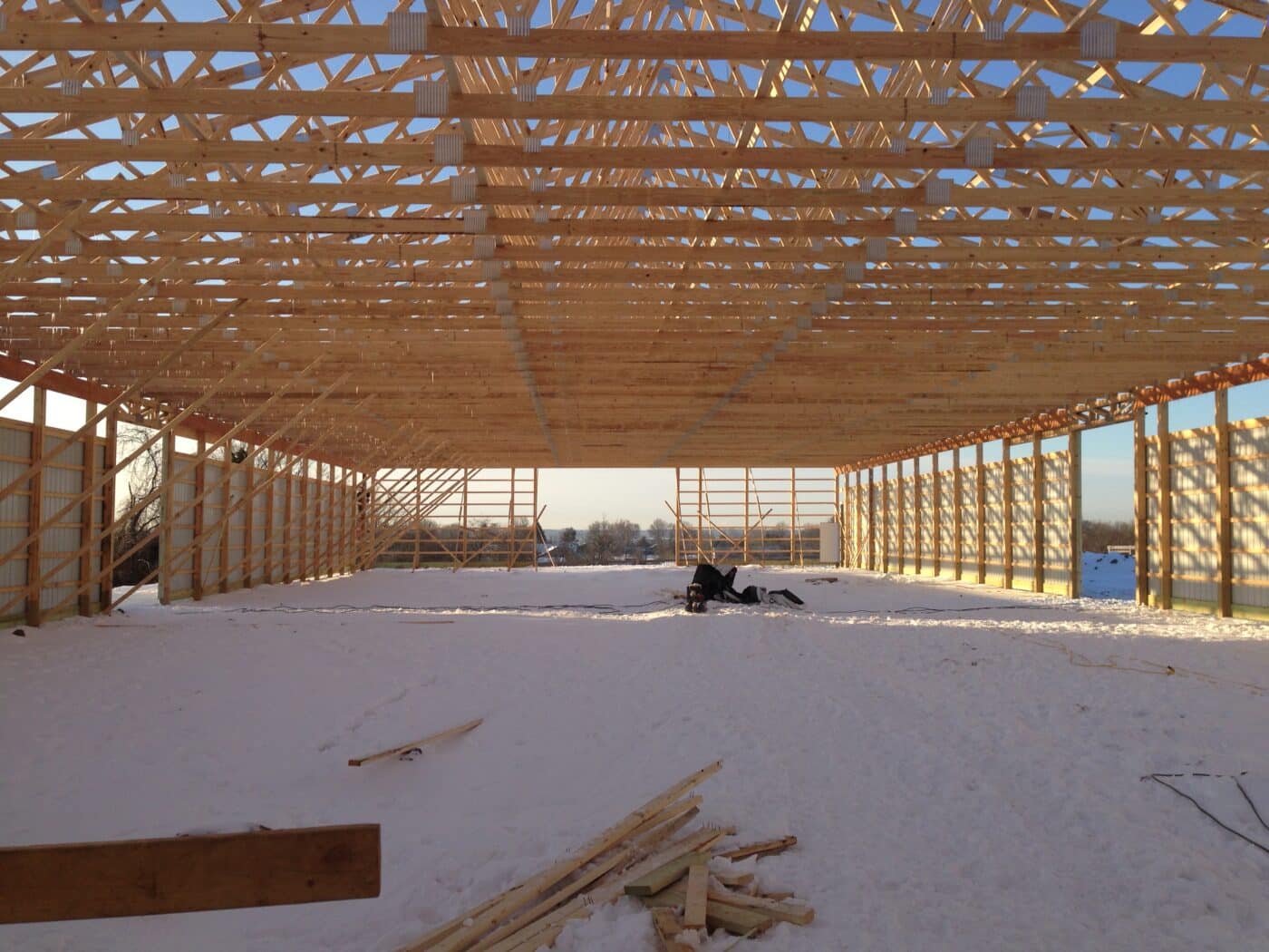 wooden roof trusses visible from the inside of a 30x48 pole barn garage