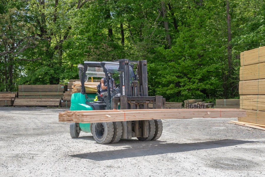forklift delivering wooden roof trusses to CMT Components wholesale customers