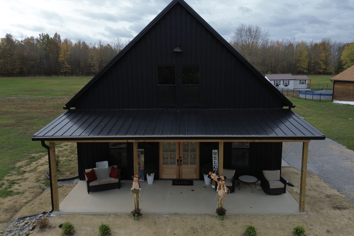 front of black 50x50 barndominium with porch