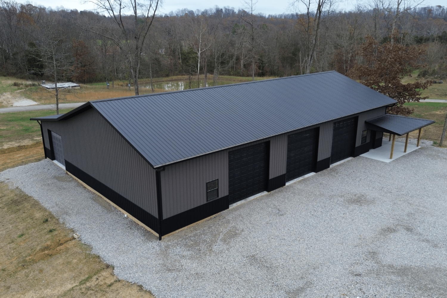 gray and black 40x100 garage pole barn kit with three black garages