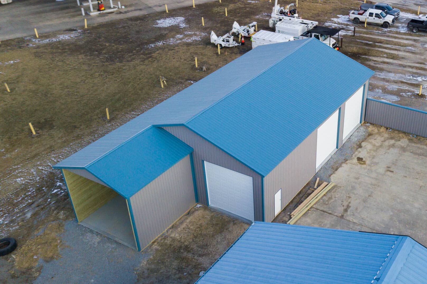 gray and blue metal roof on 60x64 commercial pole barn garage