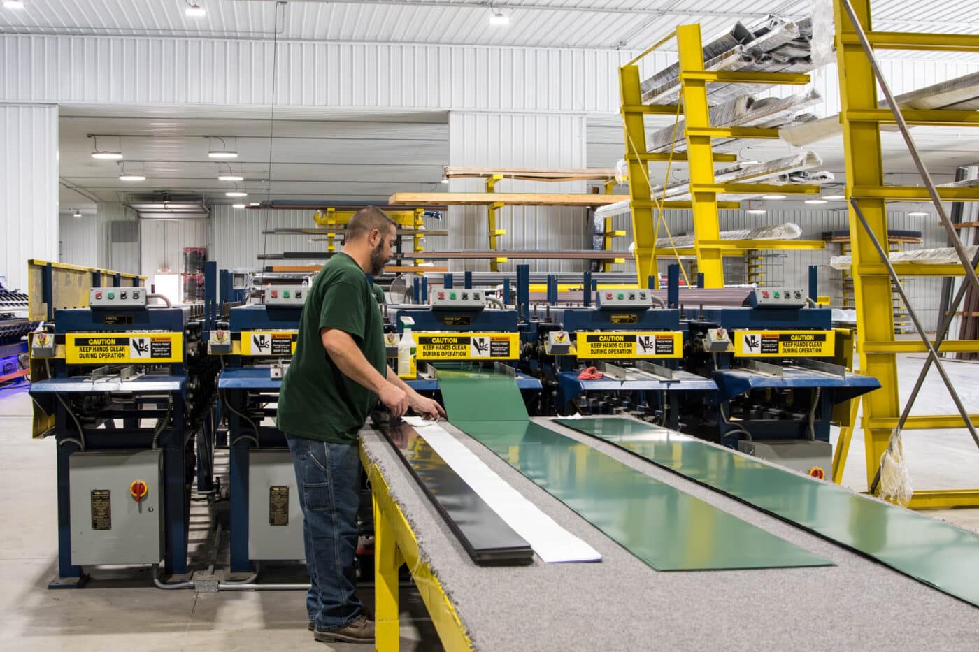 man manufacturing green metal panels