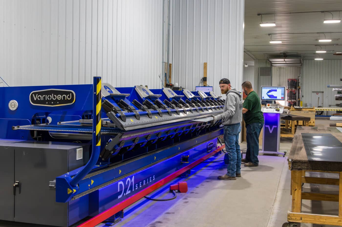 blue machine used to cut metal panels to custom specifications for 30x48 pole barn garage kits