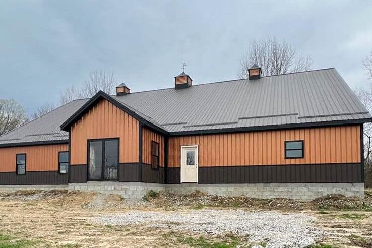 orange commercial pole barn with brown trim and brown metal roof