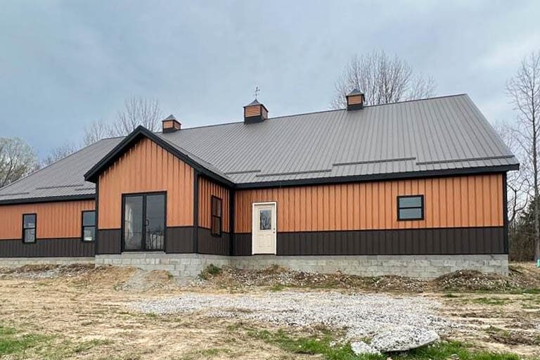 orange commercial pole barn with brown trim