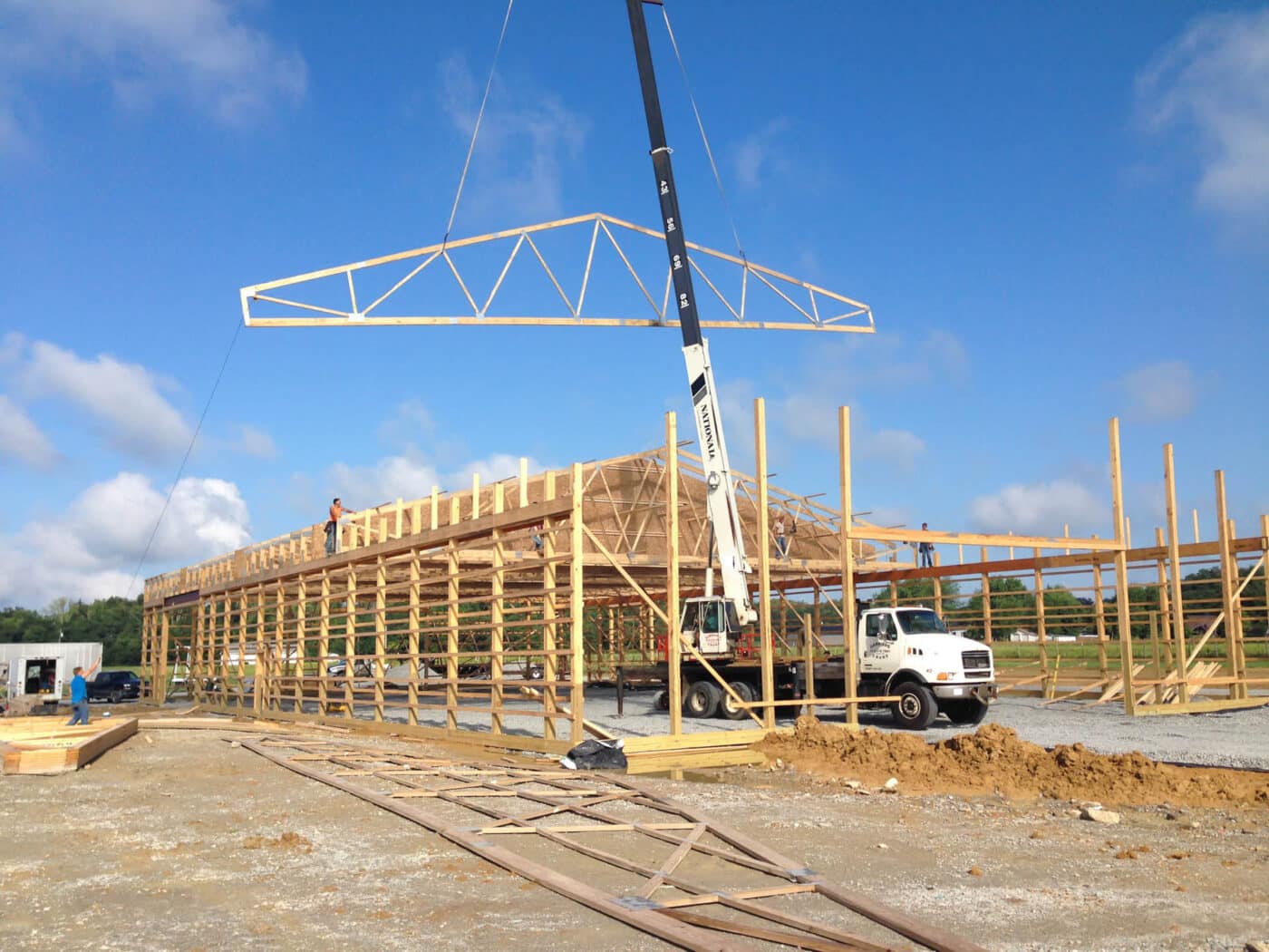 roof truss being lowered onto 60x80 commercial pole barn