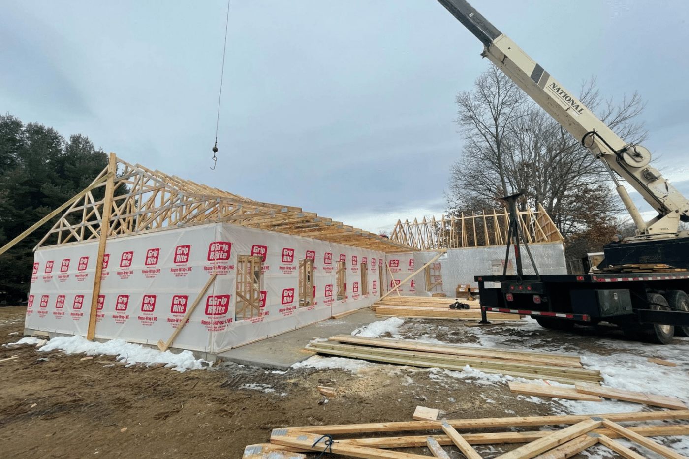 roof trusses being constructed by crane for 50x50 barndominium