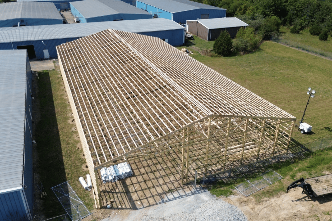 roof trusses for 50x60 garage pole barn kit being constructed