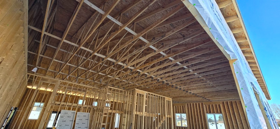 roof trusses inside garage portion of home shown through perspective of hole for garage door