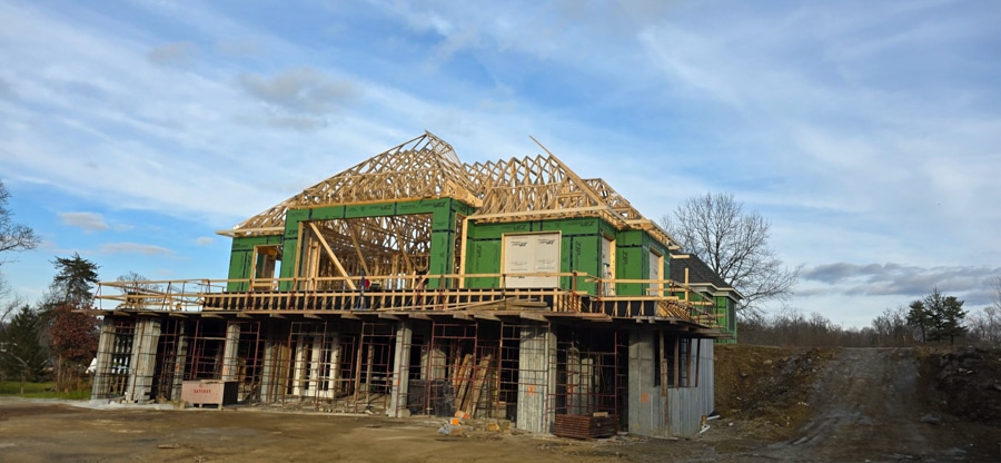 roof trusses on pool house wrapped in green