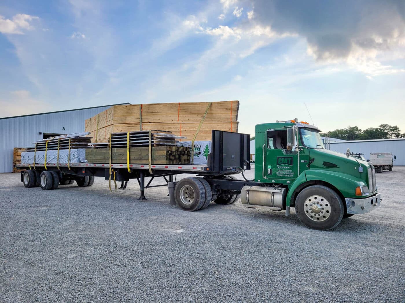 roof trusses tied on the back of a green truck