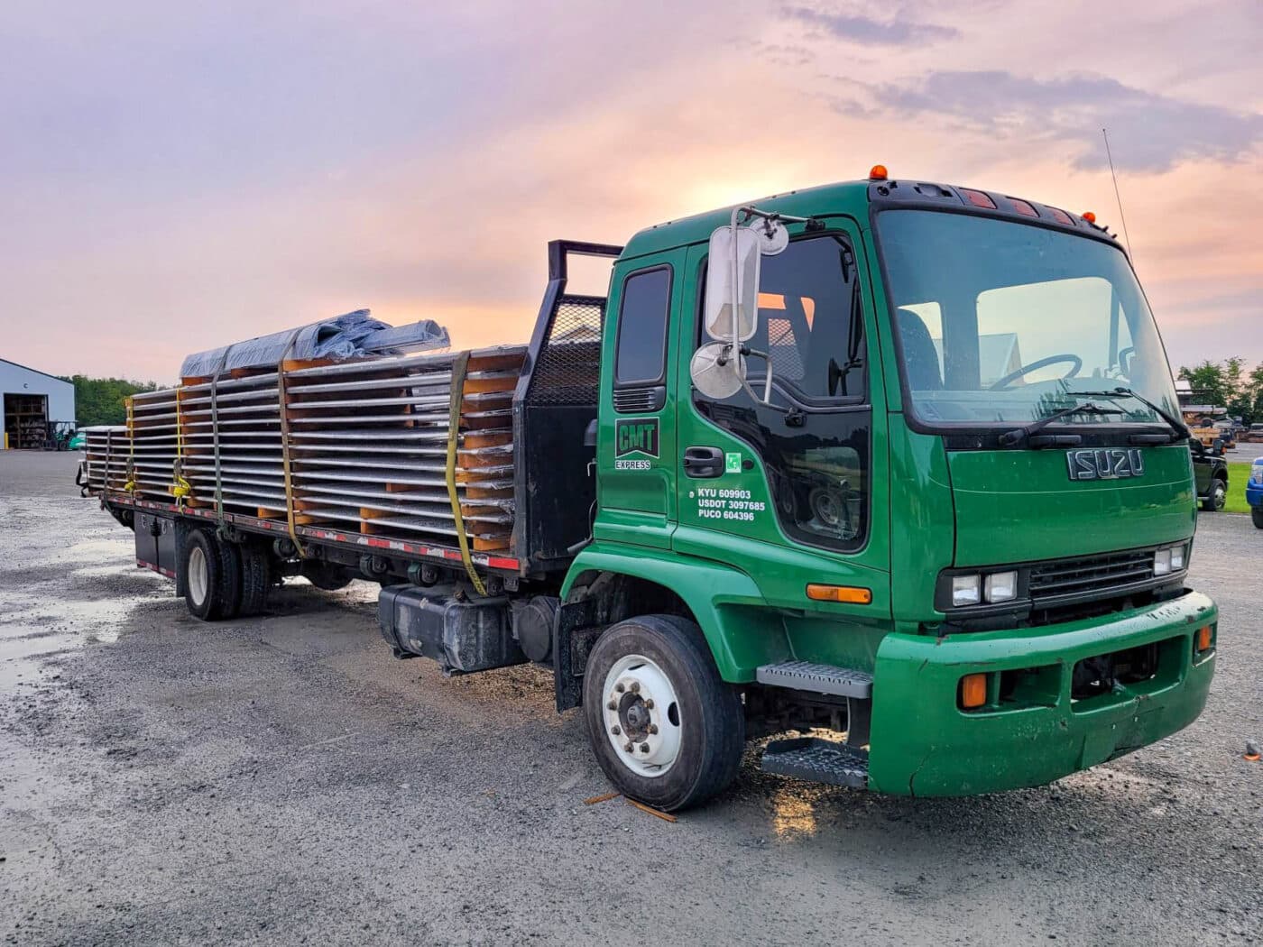 green delivery truck delivering 60x80 agricultural pole barn kits