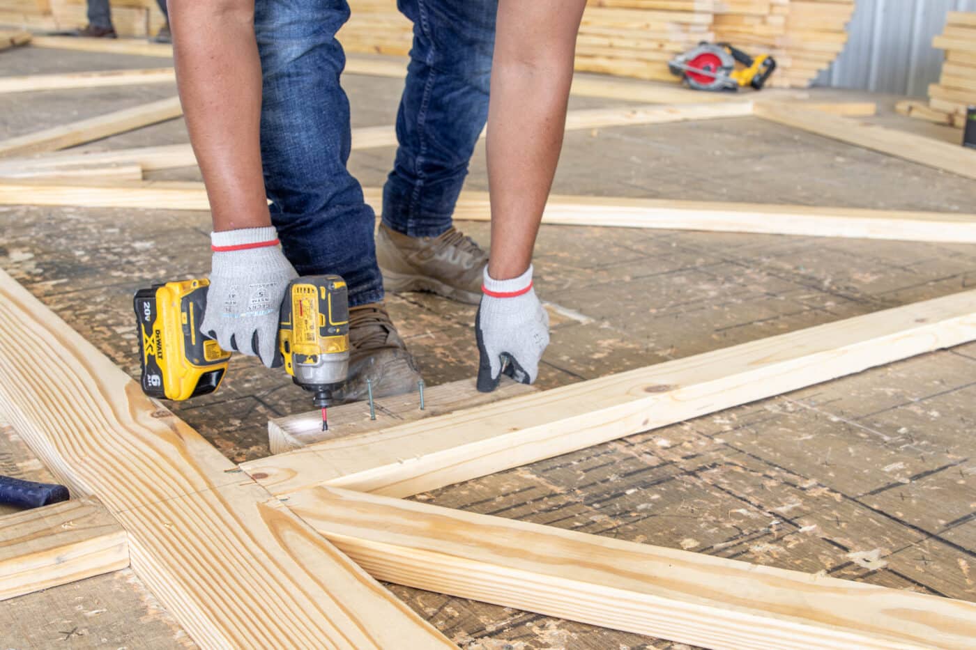 man drilling trusses for a 20x48 bardominium