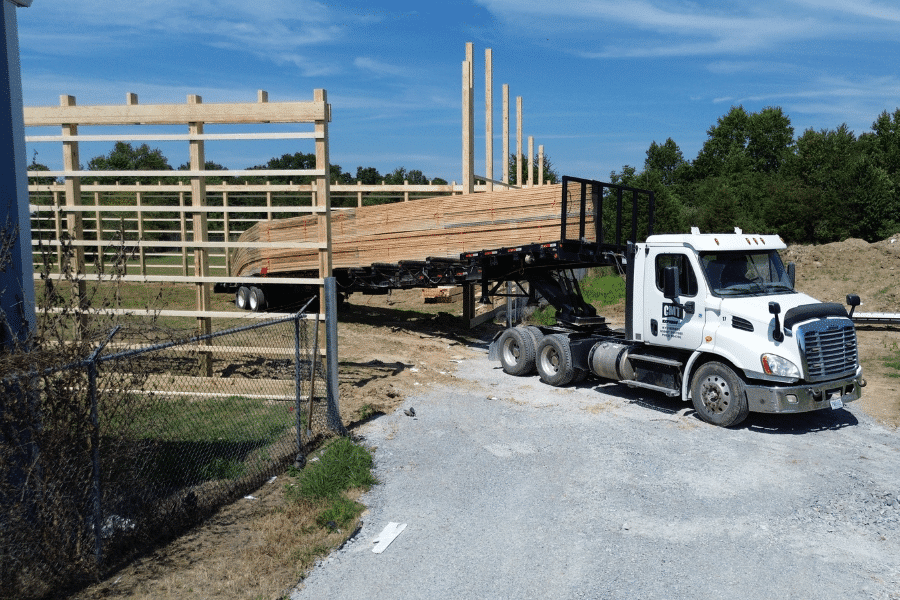 white trick delivering 42x64 agricultural post barn kits