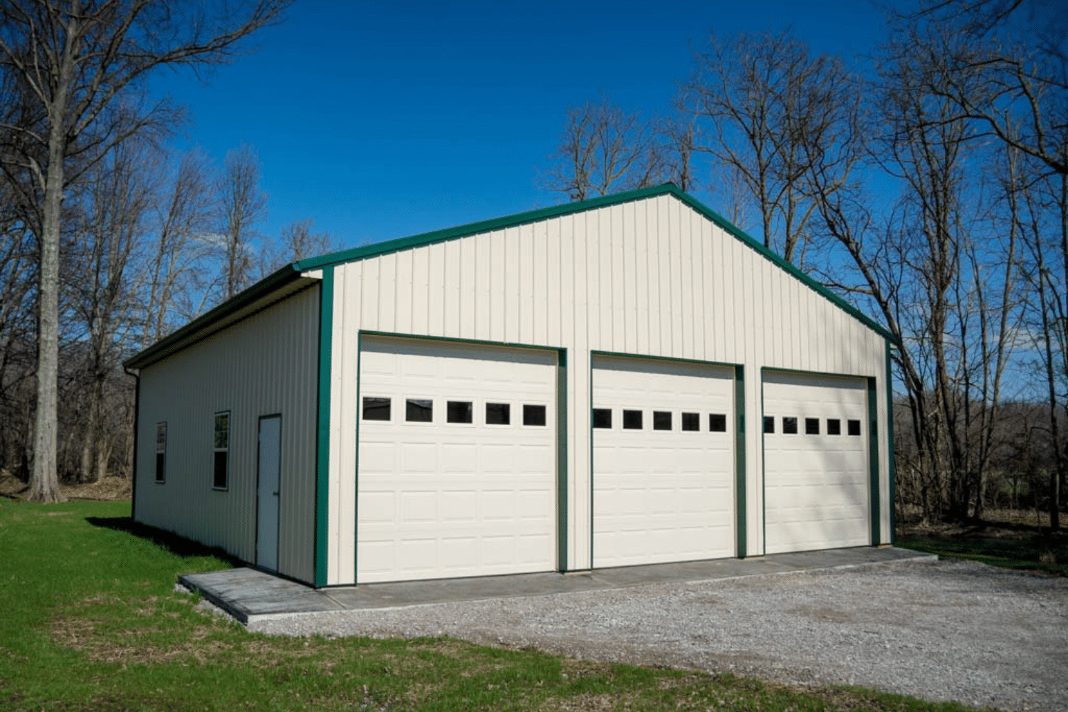 white 40x100 garage pole barn kits with green trim and three white garages