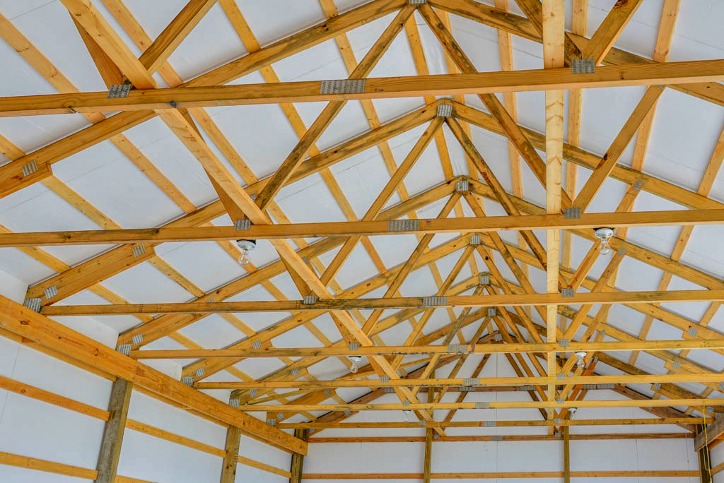 wooden roof trusses inside 36x60 agricultural pole barn with metal roofing and siding